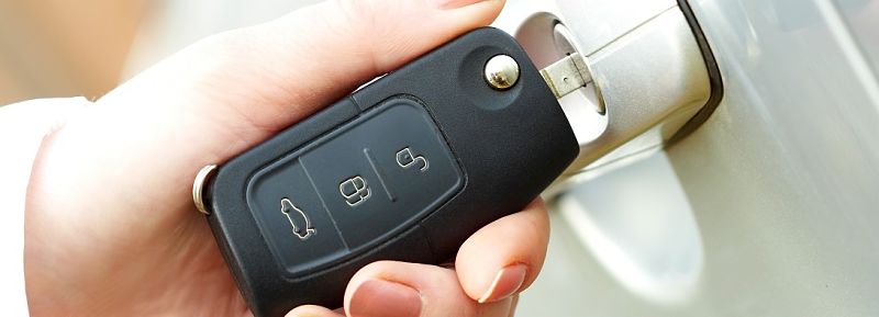 car key with door of the car.