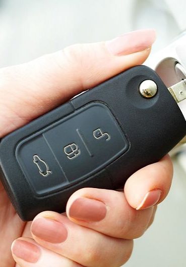 door of the car. Door of the car. A female hand with a key.